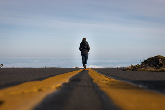 Woman walking on the line down the street above the clouds Stock Photo |  Adobe Stock