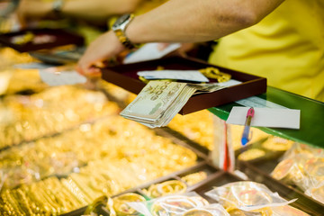 selective focus to banknote and staff with old jewelry.