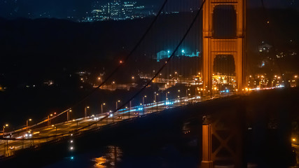 Fototapeta na wymiar Traffic passes over San Francisco's Golden Gate Bridge