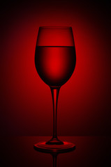 Wine glass with liquid on the background of red round gradient.