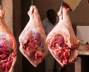 Chunks of pork hanging at a local butcher shop in central Cuba