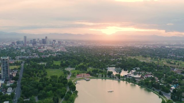 4k Aerial drone footage - Skyline of Denver Colorado at sunset from City Park.  Rocky Mountains on the horizon