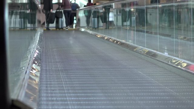 People on moving walkway at airport 4k