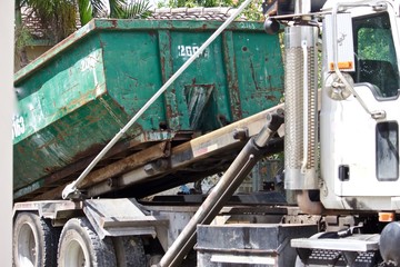 Debris from residential  construction site collected in roll-off container for efficient disposal