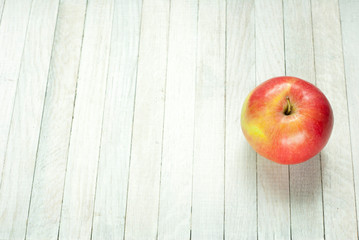 apple on white wooden table