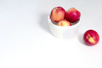 Group of whole nectarine fruits isolated on white background