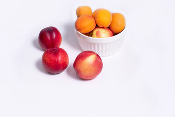 Group of whole nectarine and apricots fruit isolated on white background