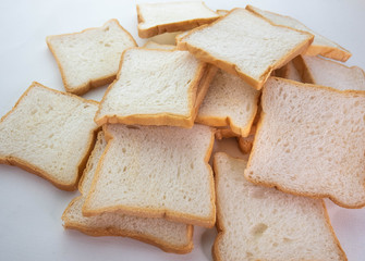 Heap of Stacked Sliced Bread on White Background.
