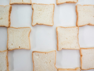 Heap of Stacked Sliced Bread on White Background.
