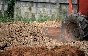 Fototapeta premium The tractors are adjusting the surface soil to smooth for construction.