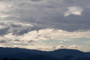 Naklejka na ściany i meble The Dark gray dramatic sky with large clouds on mountain in rainy seasons.