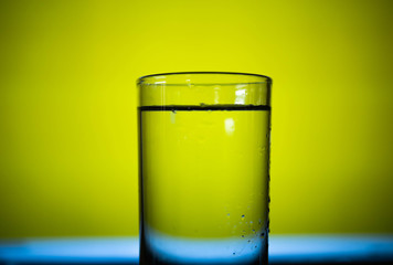 Close-up of Cool water in clear glass with steam around.