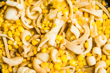 Squid warm salad with onion and corn. Selective focus. Shallow depth of field. © maxandrew