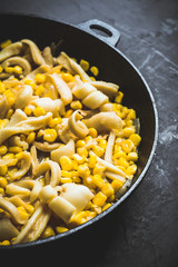 Squid warm salad with onion and corn. Selective focus. Shallow depth of field.