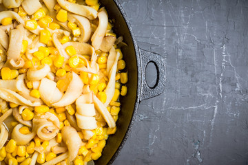 Squid warm salad with onion and corn. Selective focus. Shallow depth of field. © maxandrew