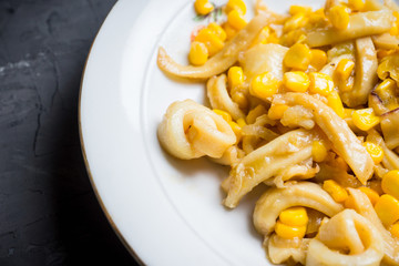 Squid warm salad with onion and corn. Selective focus. Shallow depth of field. © maxandrew