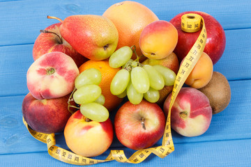 Tape measure with fresh natural fruits containing nutritious vitamins for healthy lifestyles