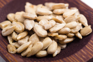 dried fruits and spices on wooden tray, white table
