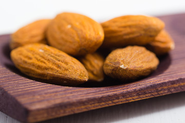 dried fruits and spices on wooden tray, white table