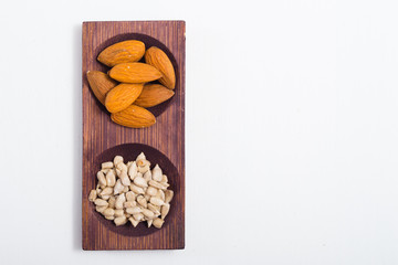 dried fruits and spices on wooden tray, white table