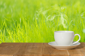 Coffee espresso on wood table nature background in garden,warm tone