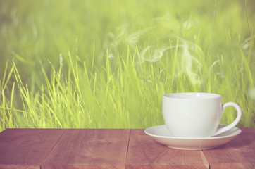 Coffee espresso on wood table nature background in garden,warm tone