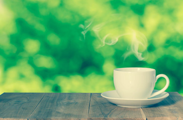 Coffee espresso on wood table nature background in garden,warm tone