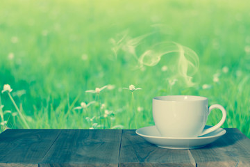 Obraz na płótnie Canvas Coffee espresso on wood table nature background in garden,warm tone