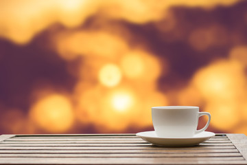 Coffee espresso on wood table nature background in garden,warm tone