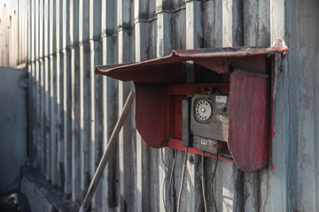 Old phone in a red box on the wall of the mine