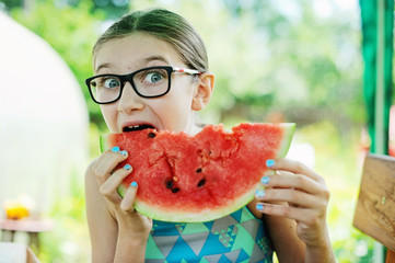 Kid girl eating watermelon