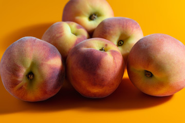 juicy fresh ripe peach on orange matte background