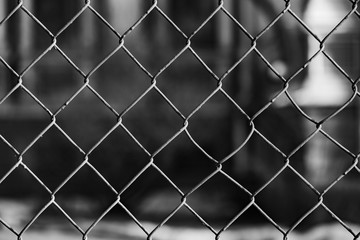 Metal grid fence on a dark background