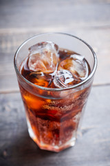 Refreshing cold cherry cola on the wooden background. Selective focus.