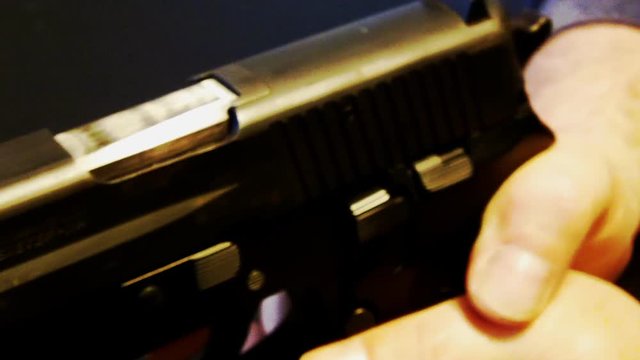 CU Finger On Trigger Of .45 Calibur Handgun Pistol