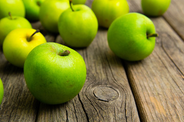 green apples on old wooden background