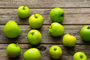 green apples on old wooden background