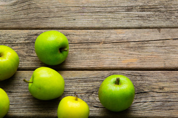 green apples on old wooden background