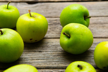 green apples on old wooden background