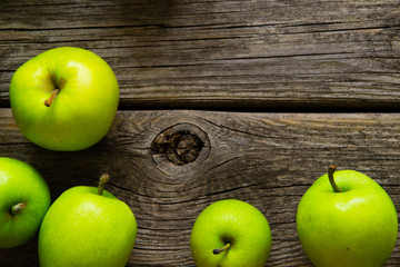 green apples on old wooden background