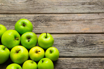 green apples on old wooden background