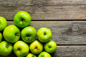 green apples on old wooden background