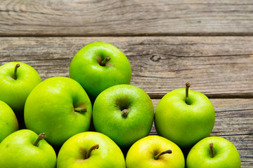 green apples on old wooden background