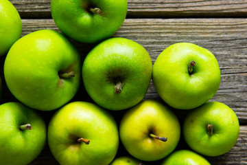 green apples on old wooden background