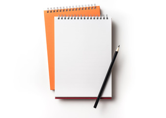 orange spiral notebook on white background