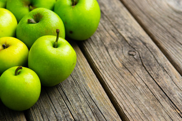 green apples on old wooden background