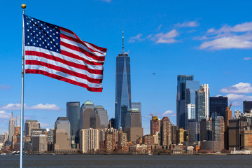 Scene of Flag of America over New york cityscape river side which location is lower...