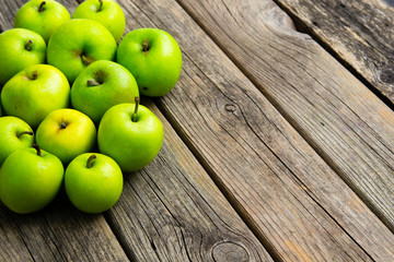 green apples on old wooden background