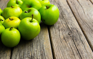 green apples on old wooden background