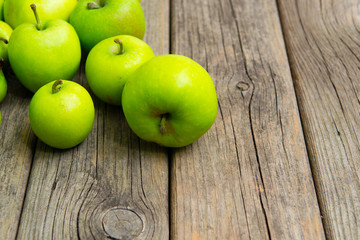 green apples on old wooden background